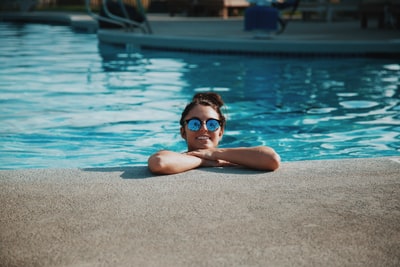 In the swimming pool with sunglasses for women during the day
